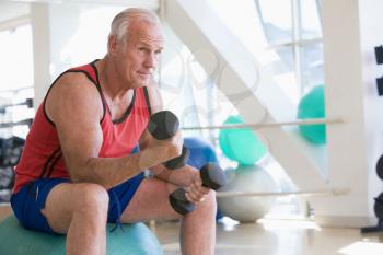 Royalty Free Photo of a Man Using Hand Weights