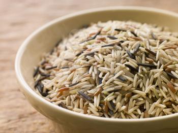 Royalty Free Photo of a Bowl of Uncooked Wild, Basmati and Red Carmague Rice