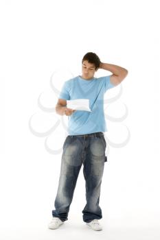 Royalty Free Photo of a Boy Holding a Piece of Paper and Frowning