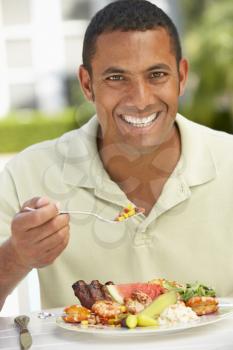 Royalty Free Photo of a Man Eating Outside