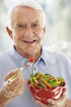 Royalty Free Photo of a Man Eating a Salad