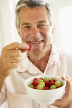 Royalty Free Photo of a Man Eating Fruit