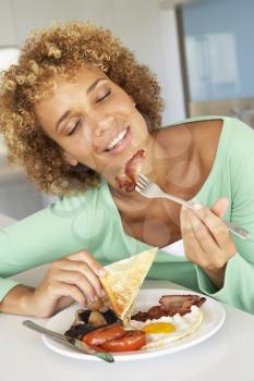 Royalty Free Photo of a Woman Eating Bacon and Eggs