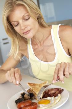 Royalty Free Photo of a Woman Eating Bacon and Eggs