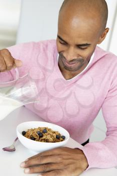 Royalty Free Photo of a Man Eating Breakfast