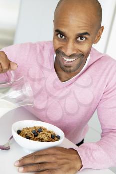 Royalty Free Photo of a Man Having Cereal