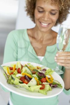 Royalty Free Photo of a Woman With a Salad and Wine