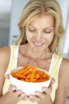 Royalty Free Photo of a Woman Holding a Bowl of Carrots