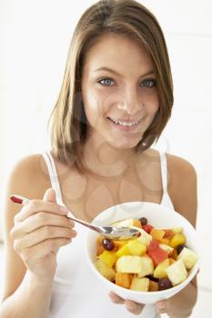 Royalty Free Photo of a Girl Eating Fruit Salad