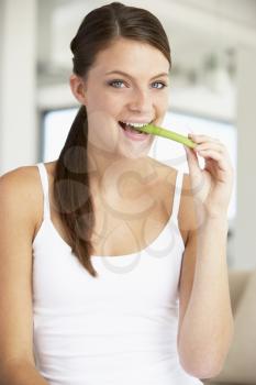 Royalty Free Photo of a Girl Eating a Celery Stick