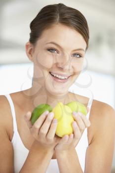 Royalty Free Photo of a Girl Holding Fruit