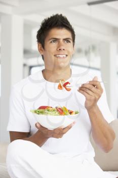 Royalty Free Photo of a Guy Eating a Salad