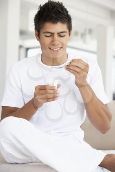 Royalty Free Photo of a Man Eating Yogurt