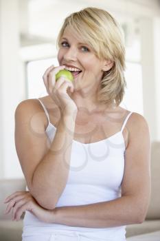 Royalty Free Photo of a Woman Eating an Apple
