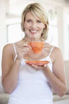 Royalty Free Photo of a Woman With an Orange Teacup