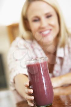 Royalty Free Photo of a Woman Reaching for a Smoothie