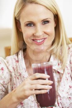 Royalty Free Photo of a Woman Drinking a Smoothie