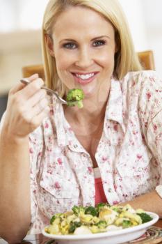 Royalty Free Photo of a Woman Eating a Healthy Meal