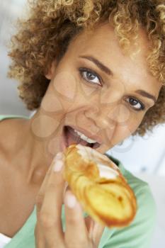 Royalty Free Photo of a Woman Eating a Pastry