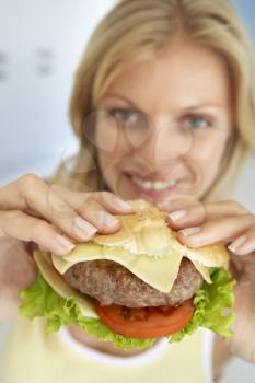 Royalty Free Photo of a Woman Eating a Burger