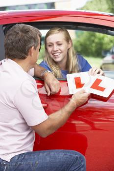 Royalty Free Photo of a Girl Receiving Her Learner's Plates