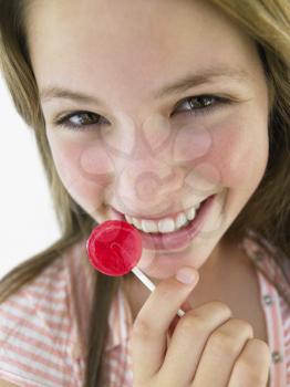 Royalty Free Photo of a Girl Eating a Lollipop