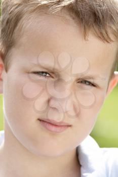 Royalty Free Photo of a Young Boy Frowning