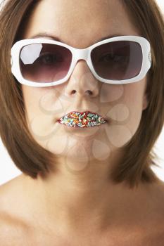 Royalty Free Photo of a Woman With Sprinkles on Her Lips Wearing Sunglasses