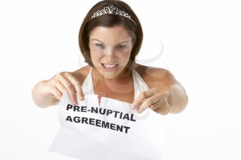 Royalty Free Photo of a Bride Tearing Up Her Prenuptial Agreement
