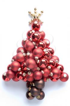 Christmas Tree Made From Red And Gold Baubles Against White Background