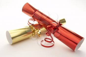 Red And Gold Christmas Crackers Against White Background