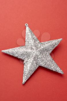 Royalty Free Photo of a Silver Star on Red