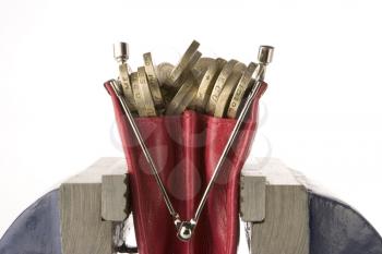 Royalty Free Photo of a Purse Full of Pounds in a Vice