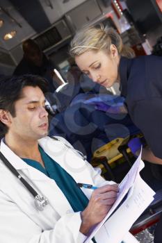 Royalty Free Photo of Paramedics Advising a Doctor