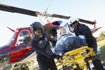 Royalty Free Photo of Paramedics Unloading a Patients From an Air Ambulance