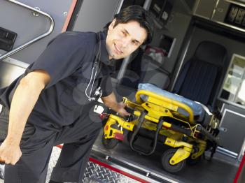 Royalty Free Photo of a Paramedic Removing a Gurney