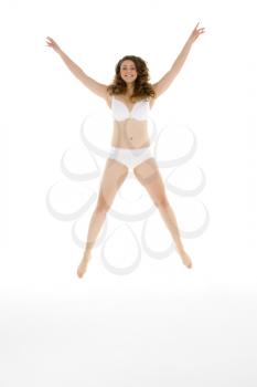Royalty Free Photo of a Girl Jumping in Her Underwear