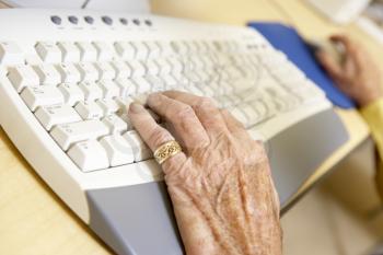 Royalty Free Photo of a Person's Hand on a Keyboard