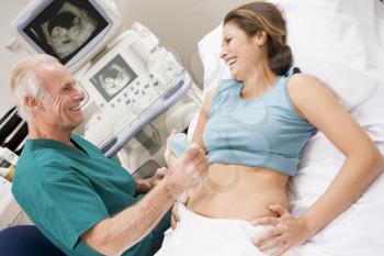 Royalty Free Photo of a Doctor Giving a Woman an Ultrasound