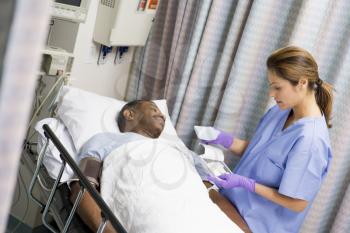 Royalty Free Photo of a Nurse Caring for a Patient