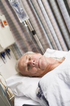 Royalty Free Photo of a Man in a Hospital Bed