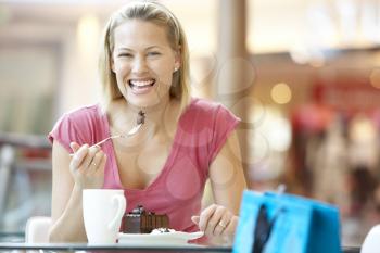 Royalty Free Photo of a Woman Having Cake at a Mall