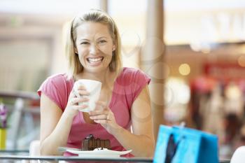 Royalty Free Photo of a Woman Having Cake at a Mall