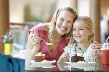 Royalty Free Photo of a Mother and Daughter Having Cake at a Mall