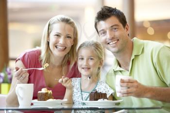 Royalty Free Photo of a Family Having Cake at a Mall