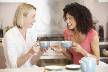 Royalty Free Photo of Two Women Having Tea and Cookies