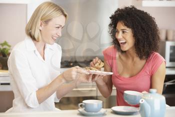 Royalty Free Photo of Two Women Having Tea and Cookies