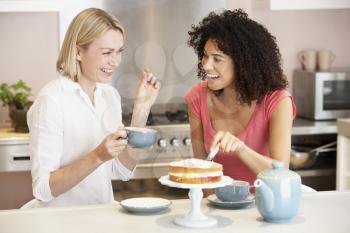 Royalty Free Photo of Two Women Having Tea and Cake