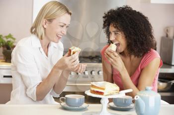 Royalty Free Photo of Two Women Having Tea and Cake