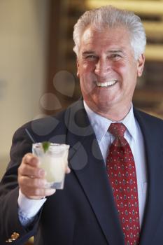 Royalty Free Photo of a Man Having a Drink at a Bar